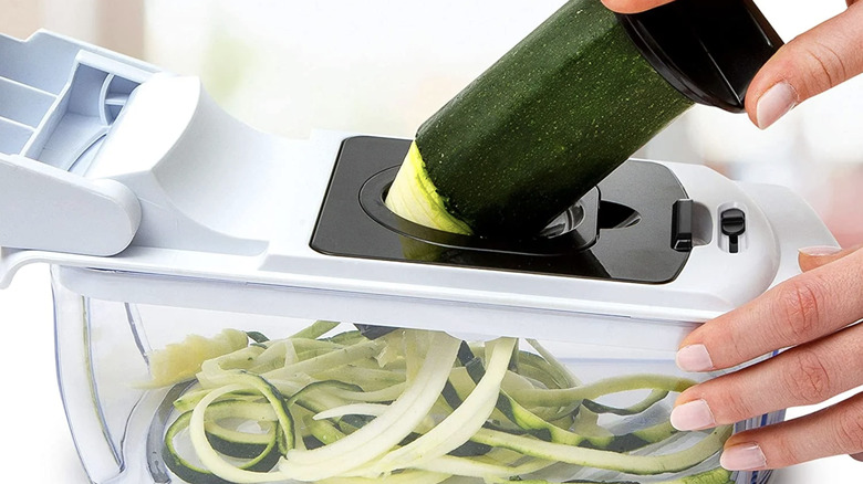 Hand spiralizing zucchini in Fullstar Vegetable Chopper