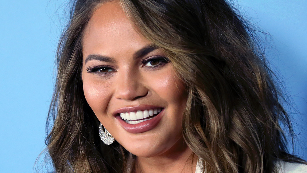 Chrissy Teigen smiling at an event