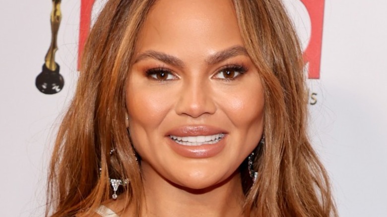 Chrissy Teigen smiling on red carpet