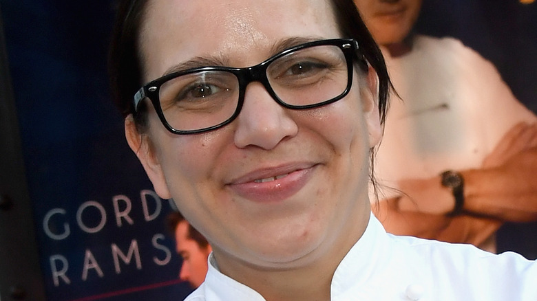 Christina Wilson smiling in glasses and chef outfit
