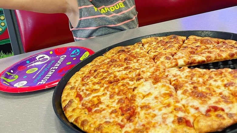 boy with Chuck E. Cheese pizza