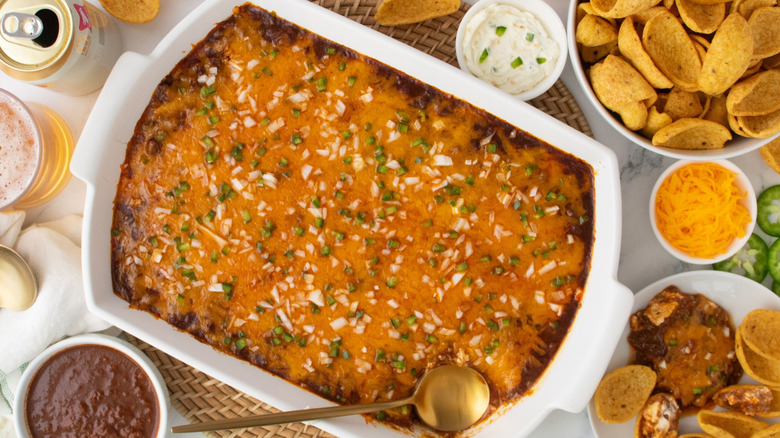 Skyline Chili dip in casserole dish next to Fritos and serving on plate