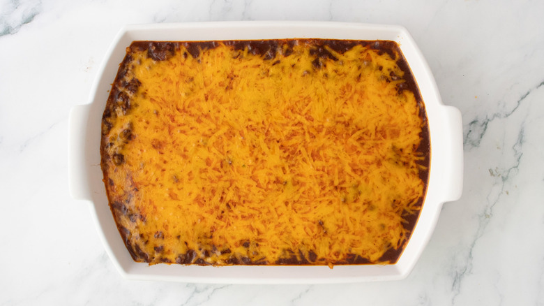 Chili dip topped with melted cheese in casserole dish