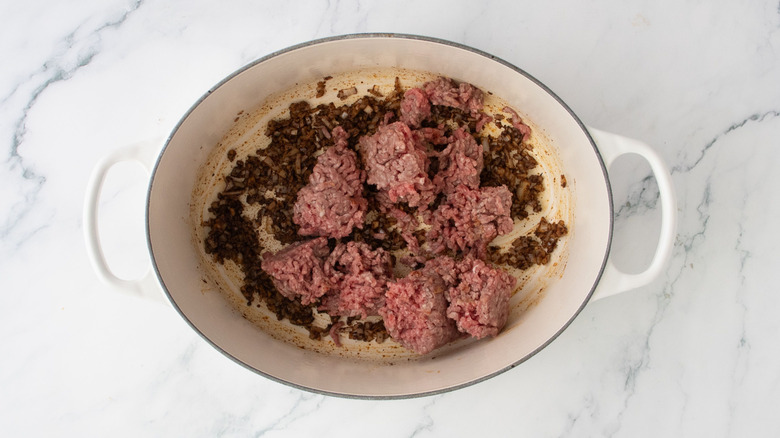 Ground beef with spiced onion and garlic in pot