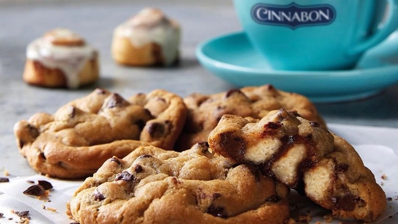 Cinnamon roll stuffed cookies next to blue mug