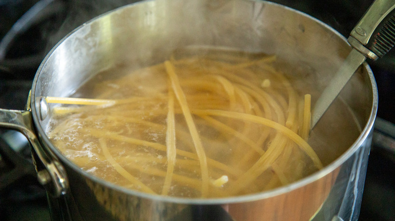 bucatini cooking in pot