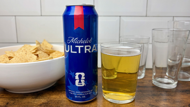 A blue can of Michelob ULTRA beside a glass of beer