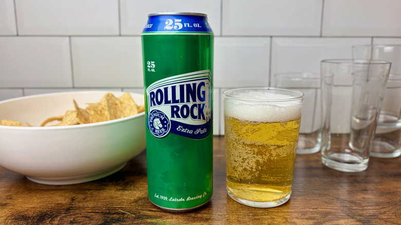 A green can and glass of Rolling Rock Extra Pale Ale