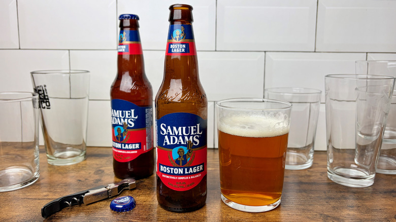 Two bottles of Samuel Adams Boston Lager next to a glass of beer
