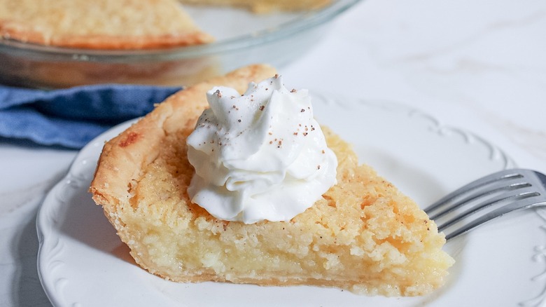 slice of buttermilk pie with whipped cream