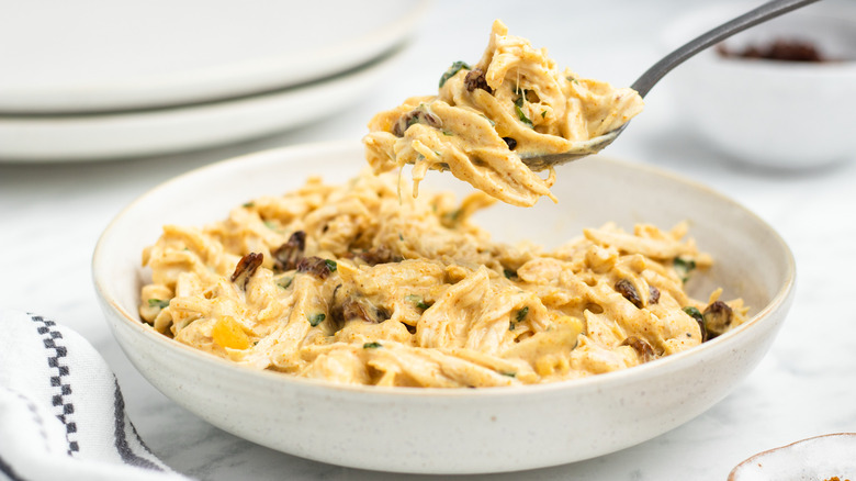 coronation chicken on spoon and in bowl