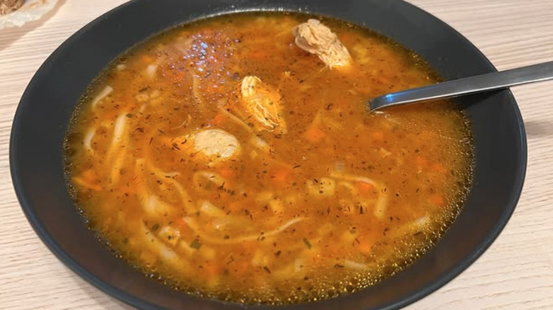 Bowl of chicken borscht with spoon
