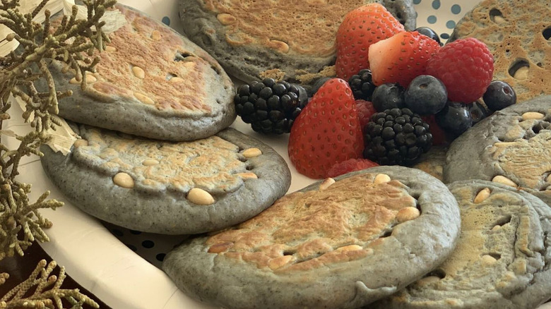 Pine nut cakes and fresh fruit on plate