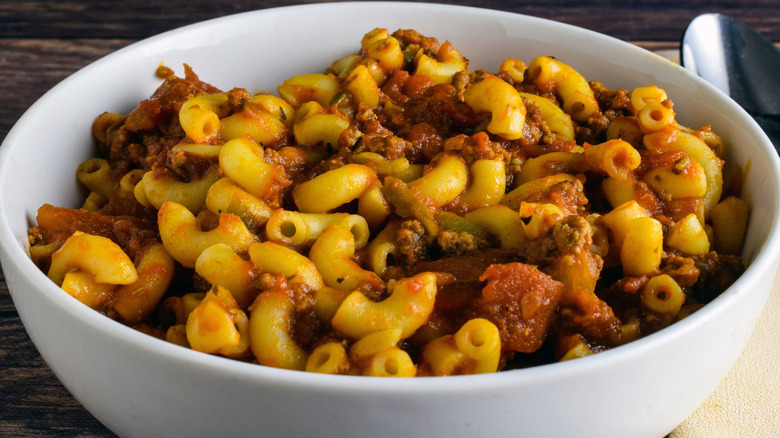 Bowl of American chop suey on wooden table