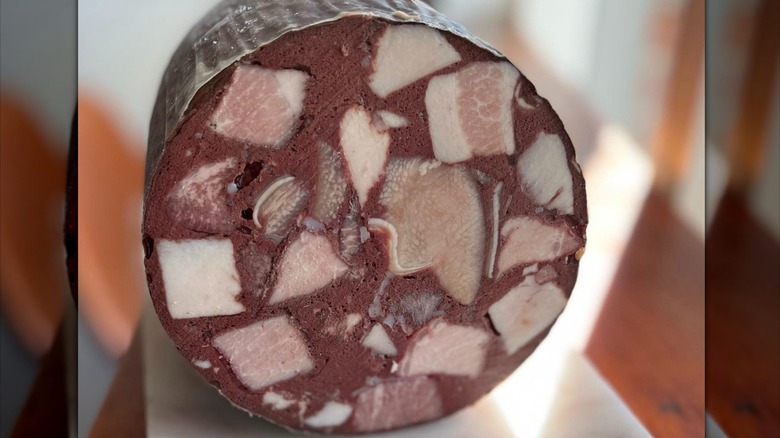 Close-up of blood sausage with meat pieces