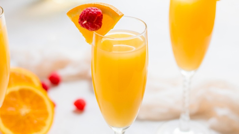 mimosa in champagne glass with garnish