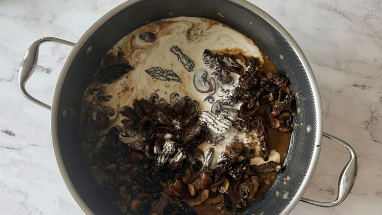 Sauteed mushrooms and cream in skillet