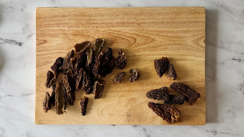 Sliced morel mushrooms on cutting board