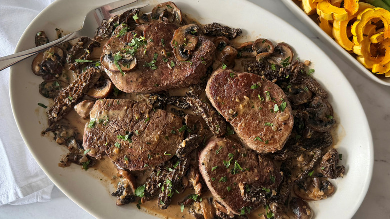 Steak Diane with mushroom sauce in serving platter