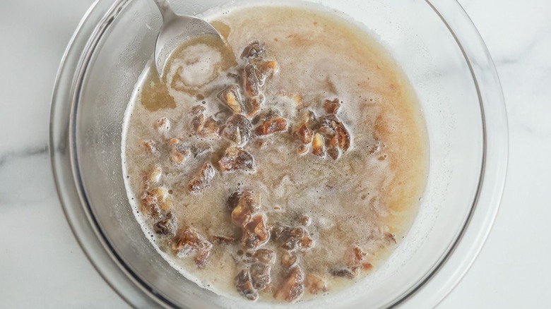 Chopped dates soaking in liquid in bowl