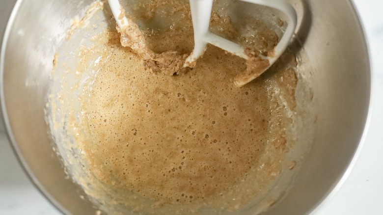Liquidy butter and sugar mixture in bowl