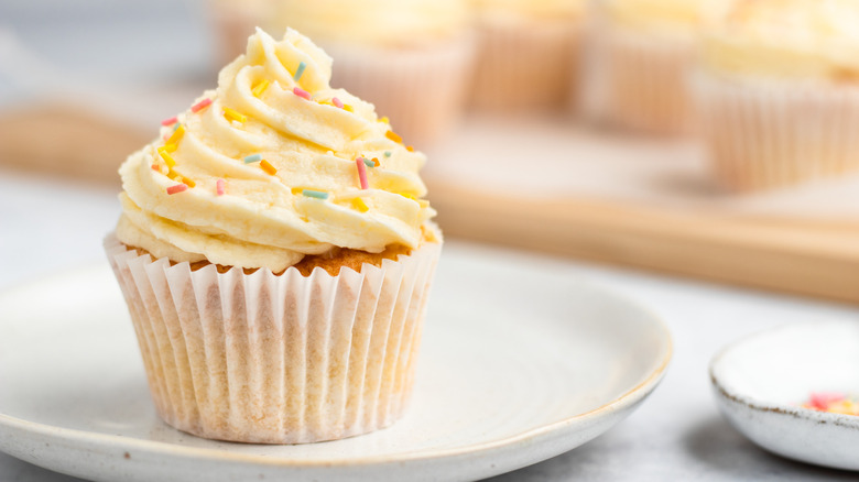 vanilla-frosted cupcake on plate