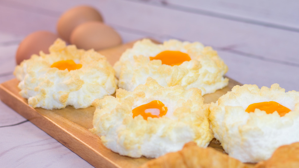 Cloud eggs on a wooden chopping board