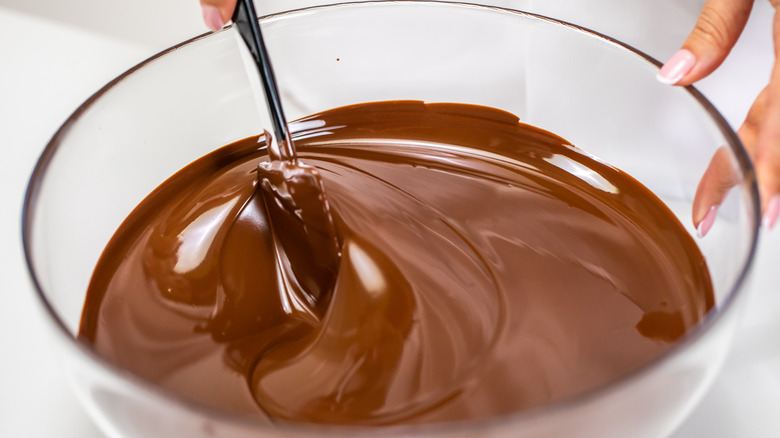 Stirring melted chocolate in bowl