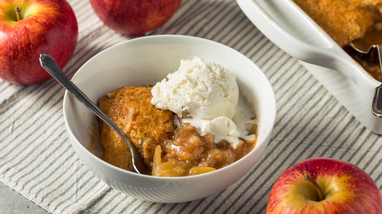 apple cobbler in bowl with ice cream