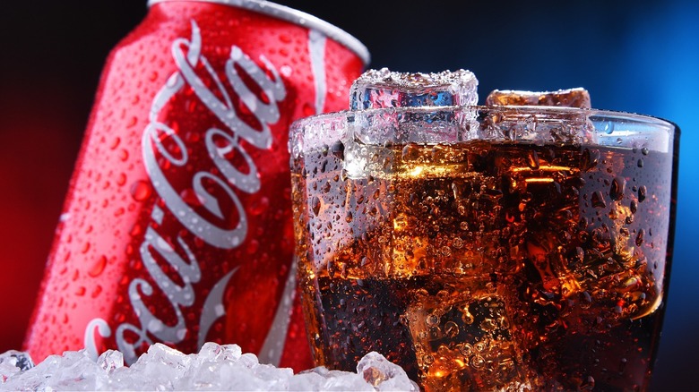 Glass of Coke with Coca-Cola can
