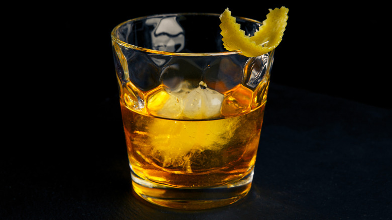 Rusty Nail cocktail on black background