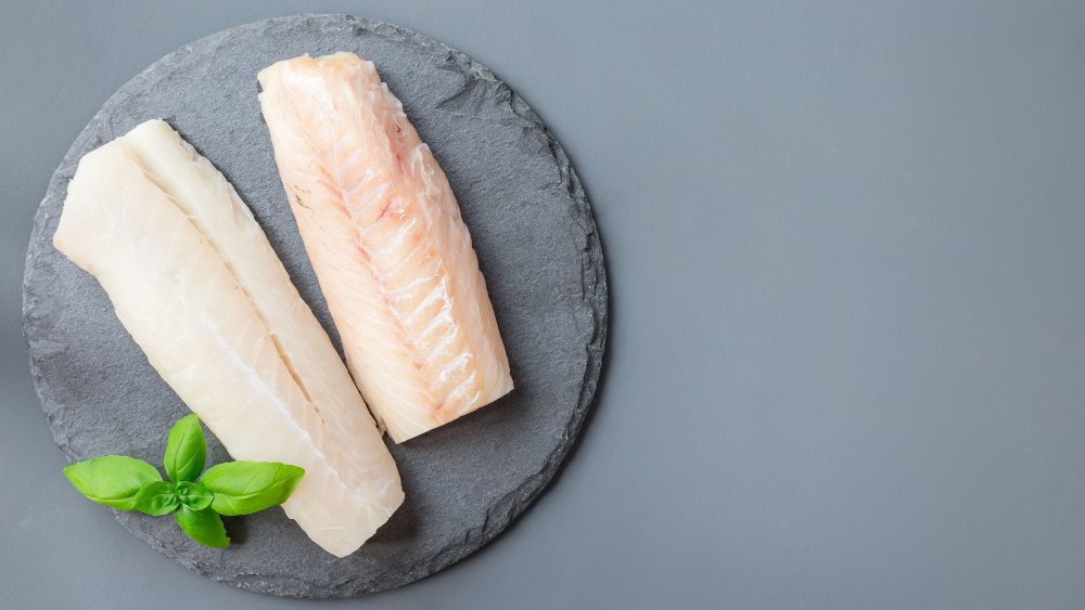 cod fillets against a stone background