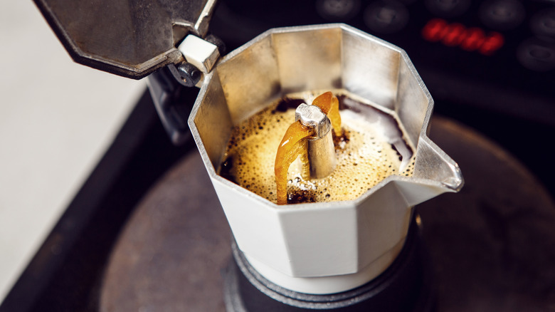 Coffee brewing in open Moka pot.