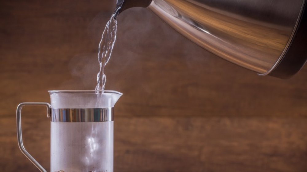 Pouring water into French press carafe