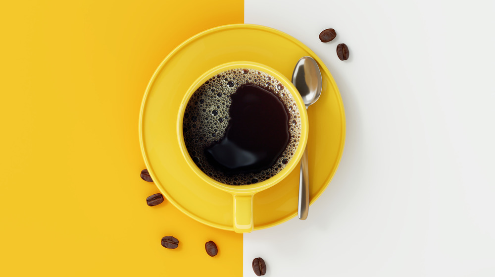 Coffee cup on yellow and white background