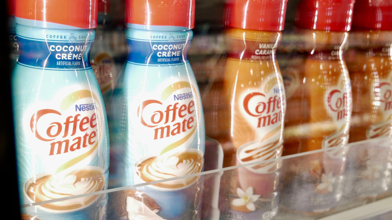 Coffee Mate creamer bottles on a grocery store shelf