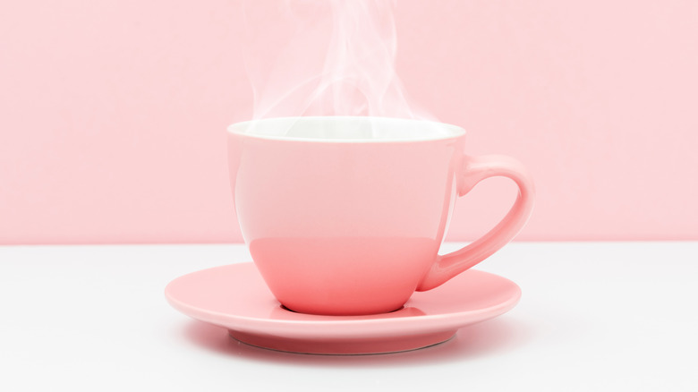 steaming pink cup on saucer