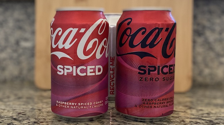 Coke Spiced cans with recycling message behind