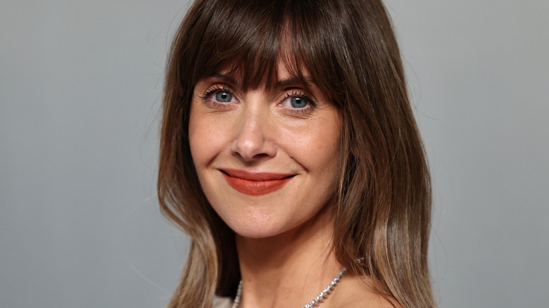 Alison Brie smiling for picture at a publicity event