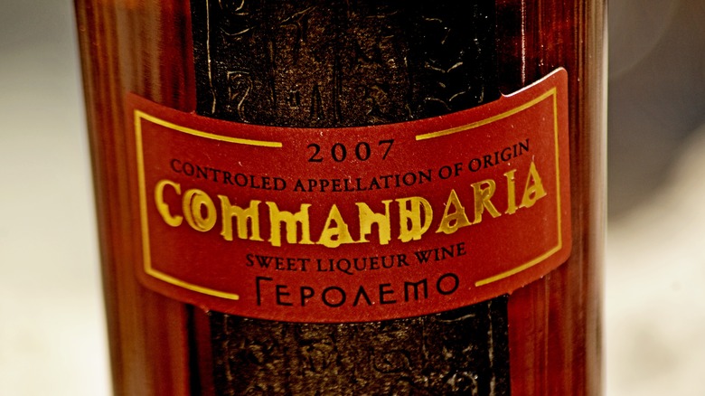 Bottle with red sticker on it that reads Commandaria 2007 sweet liqueur wine controlled appellation of orgin