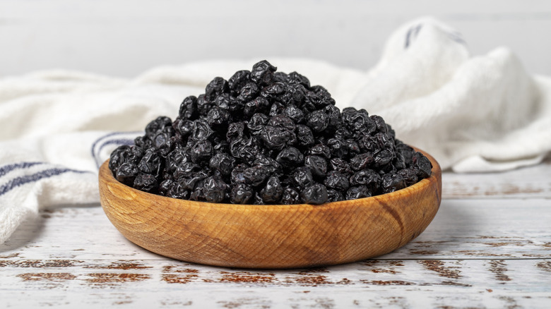 dried blueberries in a wooden bowl