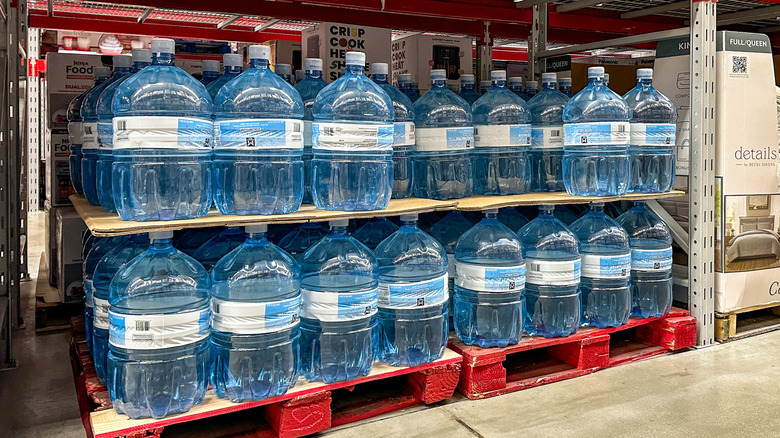 Gallons of Member's Mark purified water stacked on pallets in-store