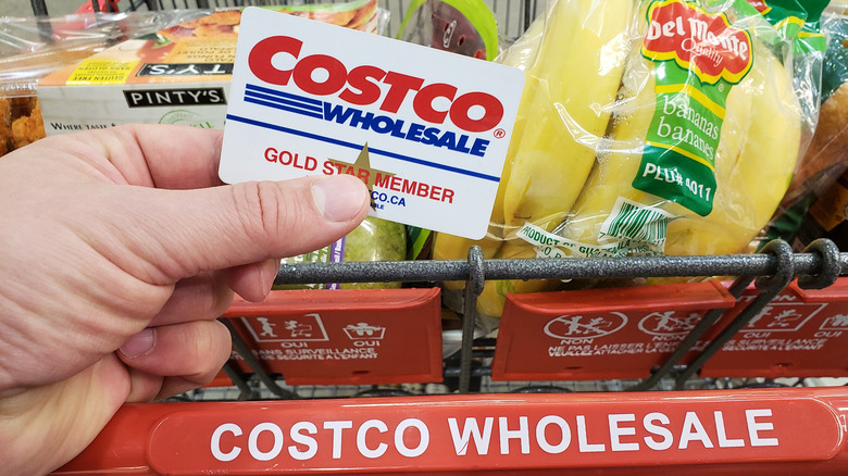 Costco customer holding membership card
