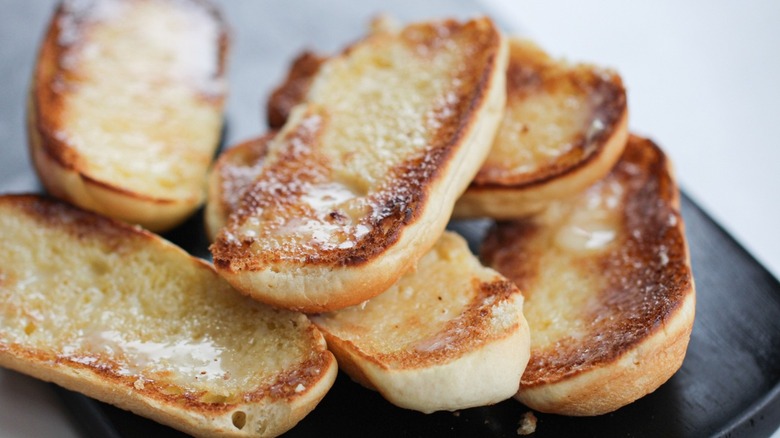 Toasted brioche bread stacked on a plate