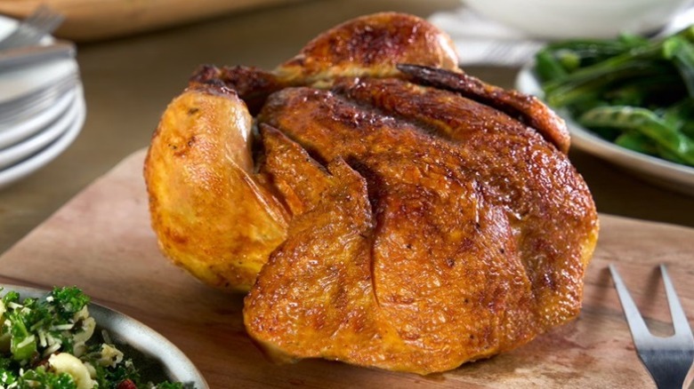 A rotisserie chicken from Sam's Club on a cutting board.