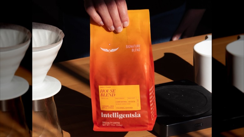 Hand holding bag of Intelligentsia House Blend coffee.