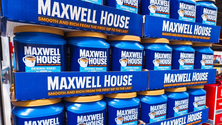 Large containers of Maxwell House coffee on display inside a warehouse store
