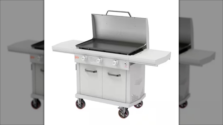 LoCo flat-top gas grill with cover open against white background.