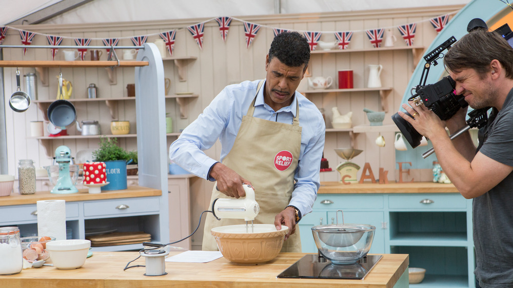 Cameraman films a man baking