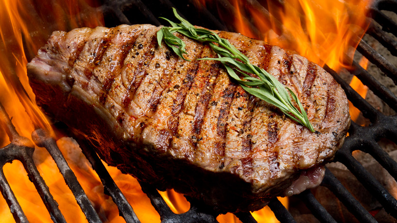 Steak on flaming grill